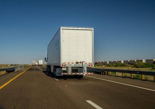 view-from-behind-of-tractor-trailer-trucks-driving-2025-01-10-19-07-29-utc-min